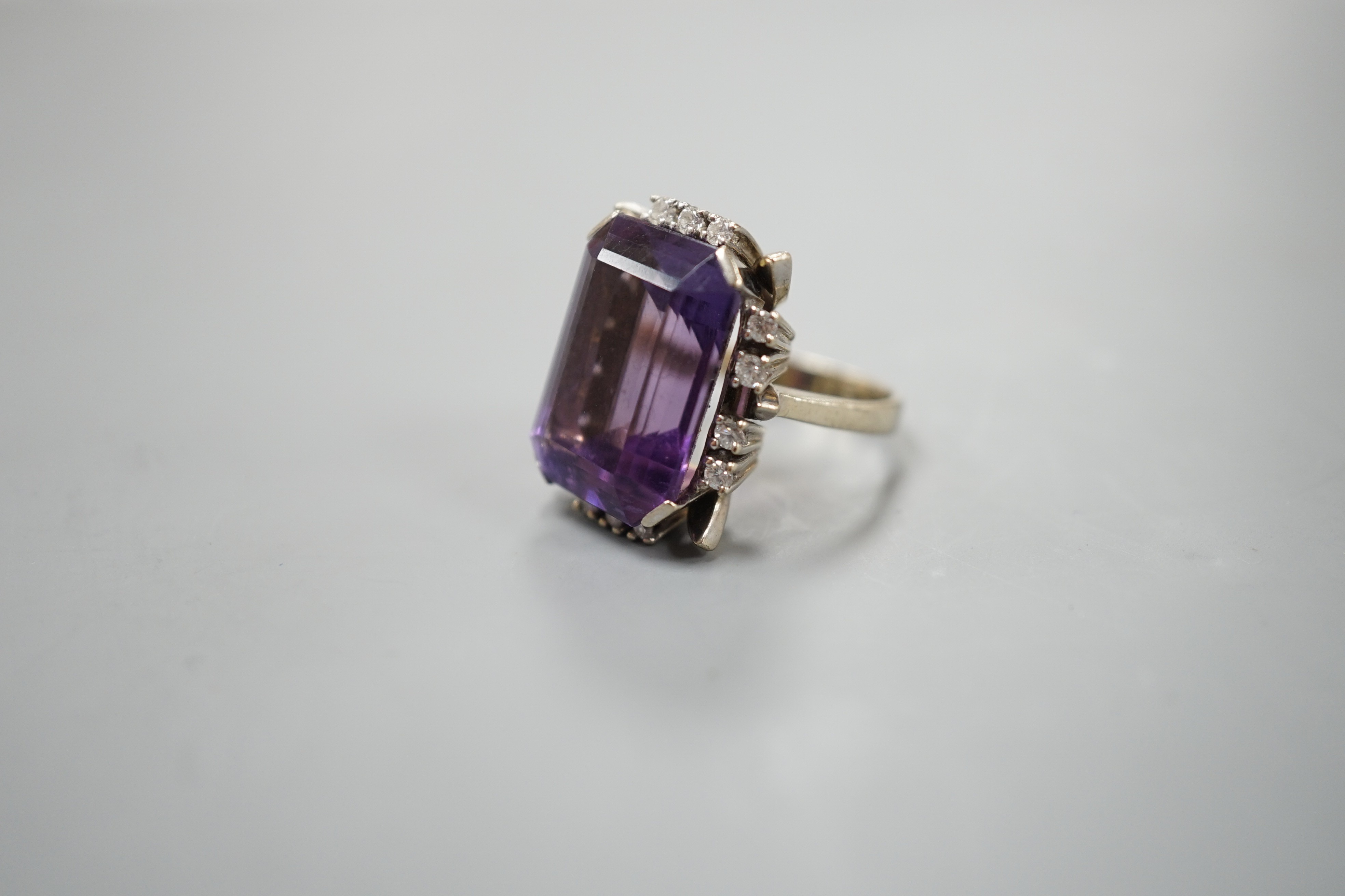 A 585 white metal emerald cut amethyst and diamond set cluster ring, size L, gross weight 11.5 grams.